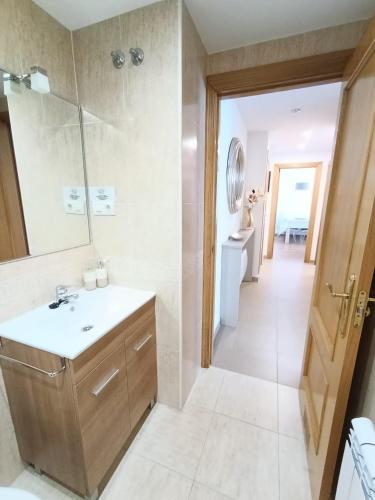 a bathroom with a sink and a mirror at La Escapada, muy cerca de Llanes in Llanes