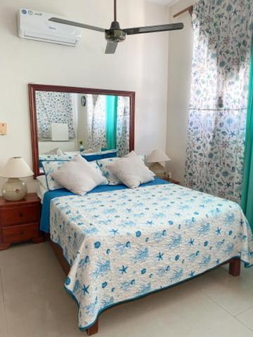 a bedroom with a bed and a large mirror at The Boat House in Boca Chica