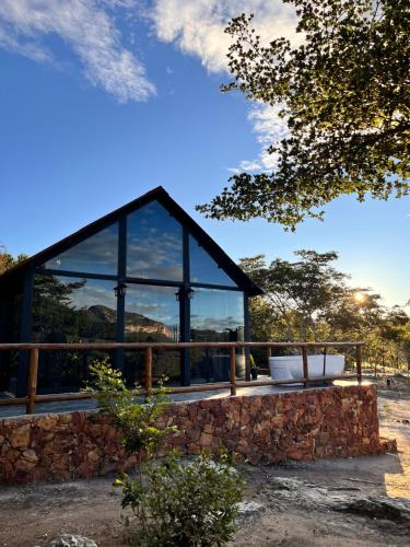 a building with a large window and a bath tub at Cabana Pegasus in Ibicoara