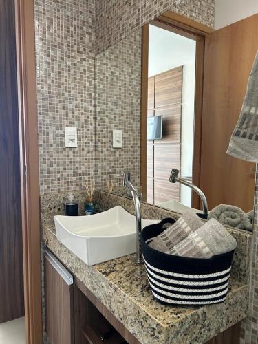 a bathroom counter with a sink and a mirror at Boulevard Plaza Flat Mirante Apto 201 in Campina Grande