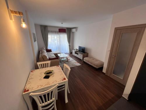 a room with a table and chairs and a living room at Podgorica Royal Apartment in Podgorica