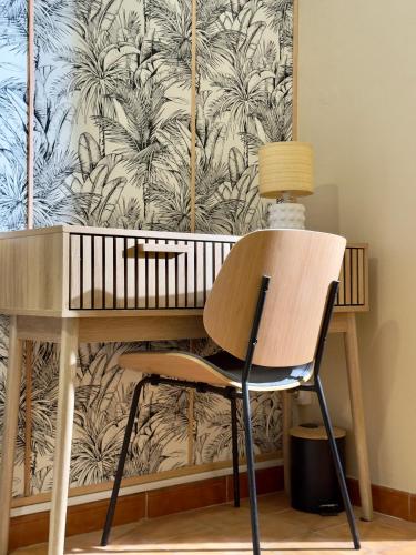 a desk with a chair in front of a wall at Le Secret de Grippon in Morne-à-lʼEau