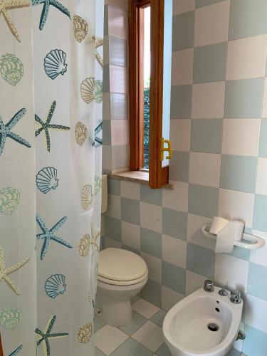 a bathroom with a toilet and a sink at UsticaTour Apartments and Villas in Ustica