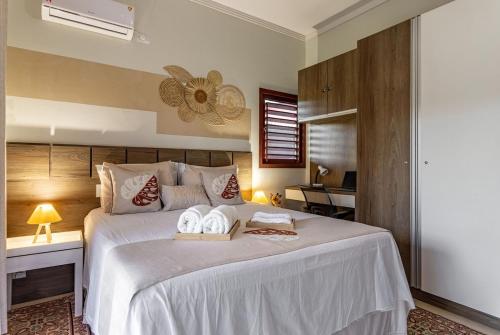a bedroom with a bed with two towels on it at Refúgio Gostoso in São Miguel do Gostoso