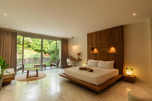 a bedroom with a large bed and a balcony at Tropical trails by wija house-unawatuna in Unawatuna