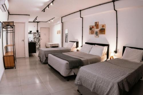 a hotel room with two beds in a room at VILLA BILAC - Large Studios close to Vila Germânica in Blumenau