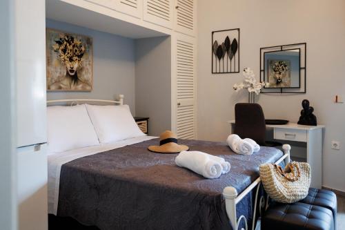 a bedroom with a bed with towels on a table at Corfu Bay Serenity Suite in Ágios Rókkos