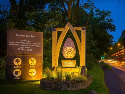 a sign for a vatican garden on the side of a road at Pinetum Garden Retreats in St Austell