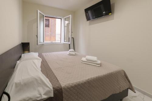 a bedroom with a bed with two towels on it at Dimora Costa Cefalù in Cefalù
