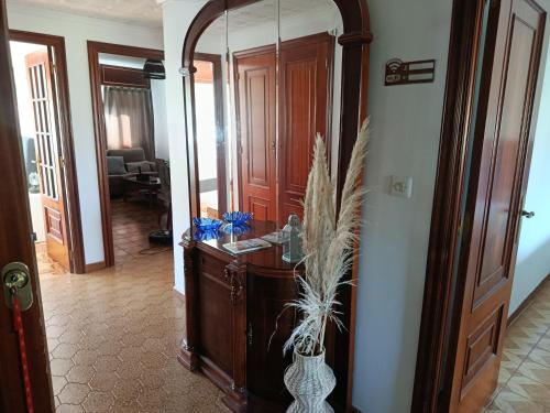 a hallway with a wooden dresser and a mirror at A Ribeira in Fene