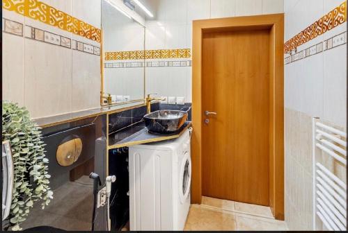 a kitchen with a sink and a washing machine at Aura centrum in Piešťany