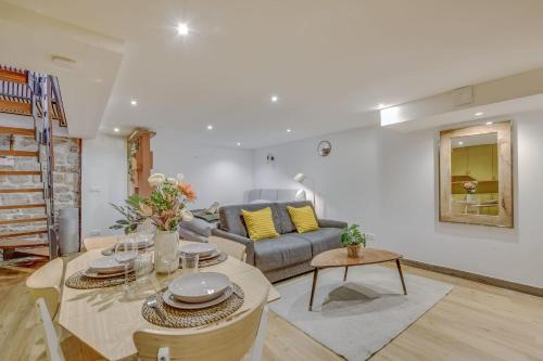 a living room with a couch and a table at Basement studio- Montparnasse Station in Paris