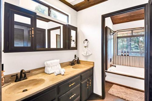a bathroom with a wooden sink and a mirror at Authentic 4BR Big Bear Cabin, Dog-Friendly with Deck in Big Bear City