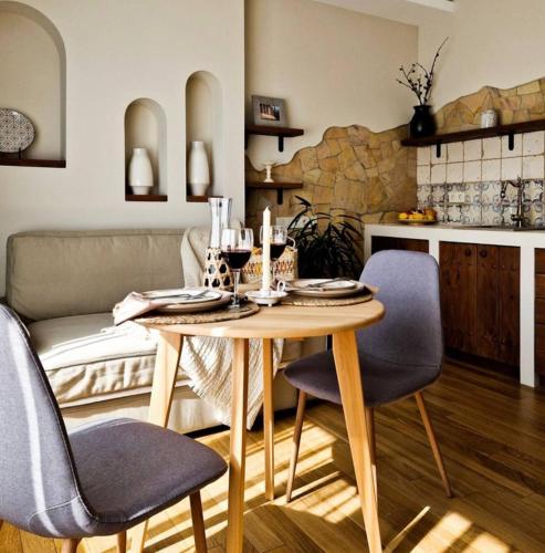 a table and chairs in a living room at Mayachok Boutique hotel in Kyiv