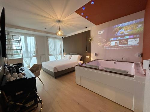 a bedroom with a bed and a tub in it at 4 Star Suite SPA - Self Check-In in Bologna