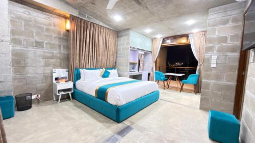 a bedroom with a blue bed in a room at Privee Dhaka - PRIVEE RESORT & RESTAURANT in Bholānāthpur