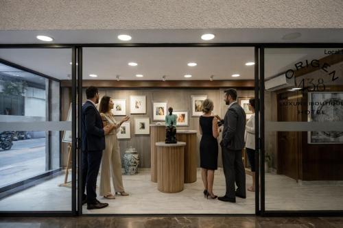 a group of people standing in a store window at Origen 438 Luxury Boutique Hotel in Guadalajara