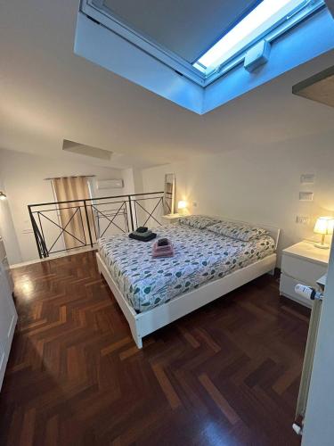 a bedroom with a bed and a wooden floor at Le Tre Capanne in Marina di Carrara