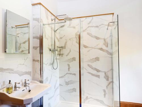a bathroom with a shower and a sink at Oak Tree in Halwell