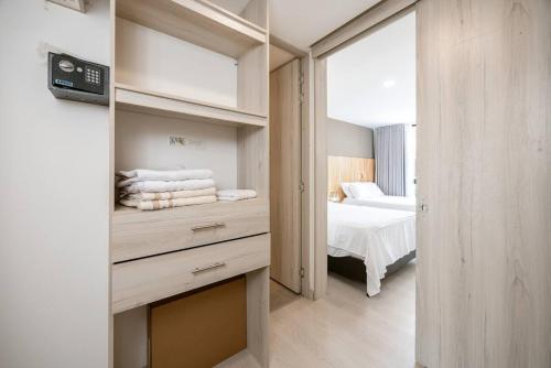 a bedroom with a bed and a large window at Luxury Jacuzzi in Poblado in El Poblado