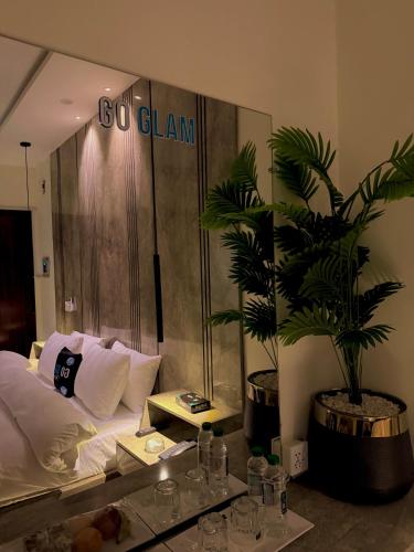 a hotel room with a bed and a large mirror at Go Glam Hotels Bahria Town in Rawalpindi