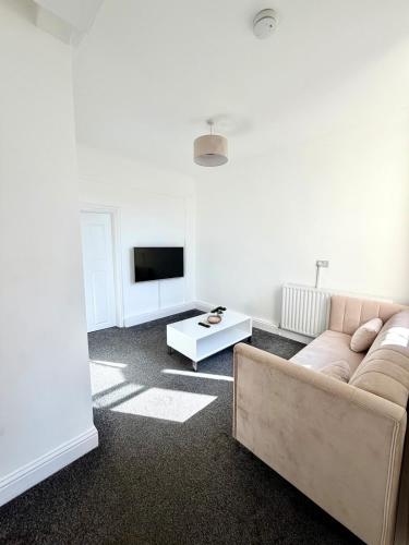 a living room with a couch and a tv at Private Apartment Free parking Gatwick Airport - One bedroom- One sofa Bed in Horley