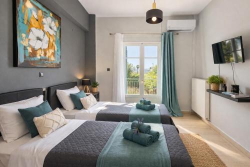 two beds with teddy bears on them in a bedroom at Ilios Place Corfu-Near Old Town & Beaches in Kontokali