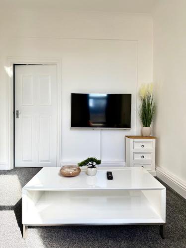 a white coffee table in a living room with a tv at Private Apartment Free parking Gatwick Airport - One bedroom- One sofa Bed in Horley