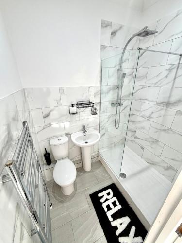 a bathroom with a toilet and a shower and a sink at Private Apartment Free parking Gatwick Airport - One bedroom- One sofa Bed in Horley