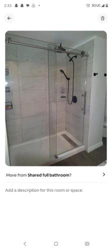 a bathroom with a shower with a glass door at Nash Place in Akron