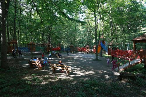 a group of people sitting on benches in a park at Lisova Pisnia Resort Hotel in Truskavets