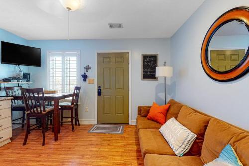 a living room with a couch and a table at Oceanbound in Folly Beach