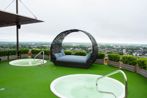 a swing chair on top of a building with green grass at GHL Hotel Grand Villavicencio in Villavicencio
