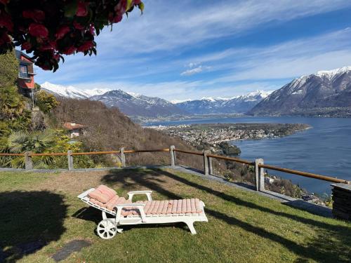 a bench sitting on top of a hill with a view at Casa Rocca Nera by HolAp in Ronco sopra Ascona