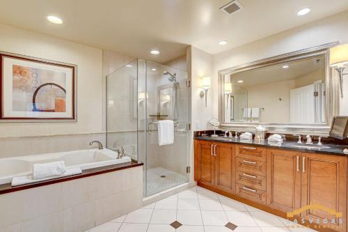 a bathroom with a tub and a shower and a sink at MGM Signature-22-615 Strip View Balcony Studio in Las Vegas