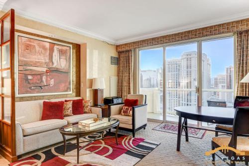 a living room with a couch and a table at MGM Signature-22-615 Strip View Balcony Studio in Las Vegas