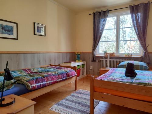 a bedroom with two beds and a window at Viol in Filipstad