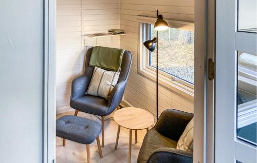 a tiny house with two chairs and a table at 1 Bedroom Beautiful Home In Nexø in Neksø
