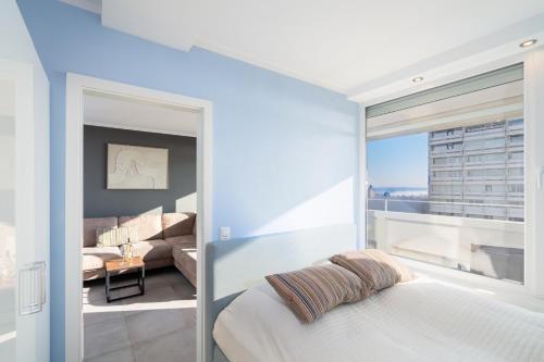 a bedroom with a bed and a living room at Panoramic App B07-1 in Sierksdorf