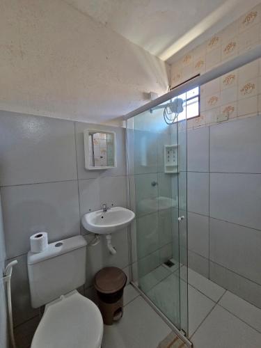 a bathroom with a toilet and a sink and a shower at Pousada SolMaris in João Pessoa