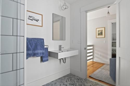 a bathroom with a sink and a mirror at Modern West End Townhome 3BR 2BA in Portland