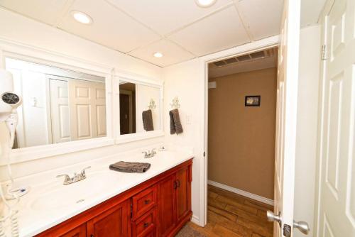 a bathroom with a sink and a mirror at Captain Jacks Pearl in Port Aransas