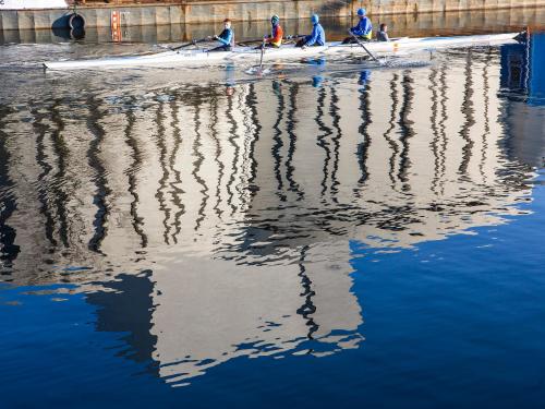 a group of people rowing a boat in the water at Softly Residence in Bydgoszcz