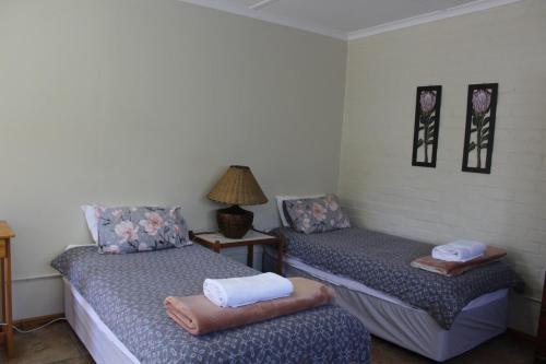 a room with two beds with towels on them at Cozy and Central Bachelor Flat in Wellington
