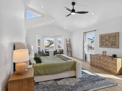a bedroom with a bed and a ceiling fan at Outrigger Beach Retreat in Oxnard