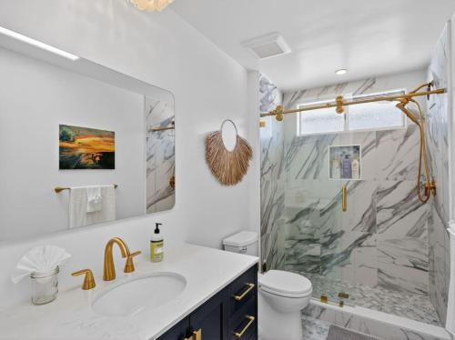a bathroom with a sink and a shower at Outrigger Beach Retreat in Oxnard