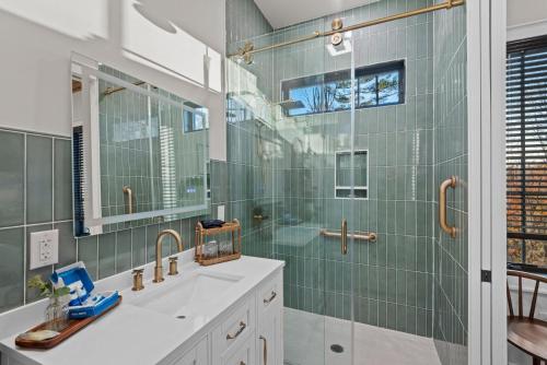 a bathroom with a sink and a glass shower at Highland House in Banner Elk