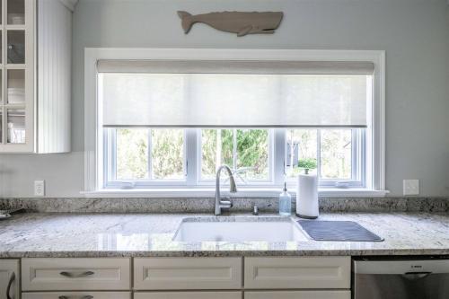 a kitchen with a sink and a window at Starboard in Kennebunk
