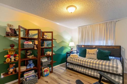 a small room with a bed and a book shelf at Our Happy Nest in Boone