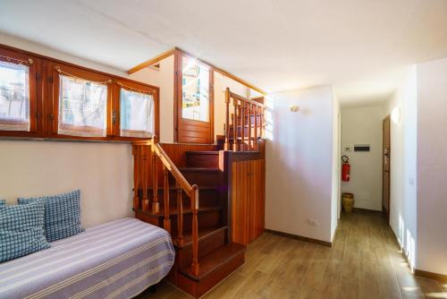 a bedroom with a staircase and a bed in a room at Ca da maina in Riomaggiore